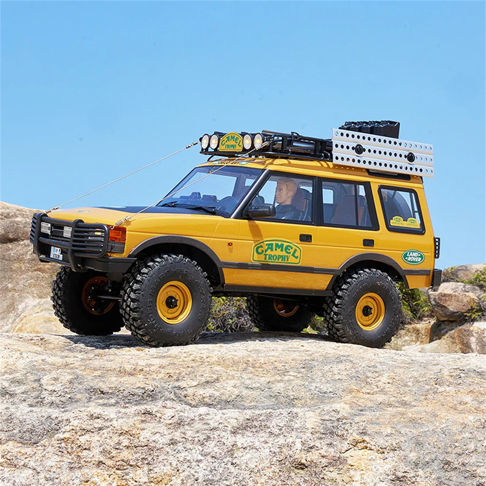 FMS FCX10 Land Rover Discovery RC Crawler - side profile action shot outdoors