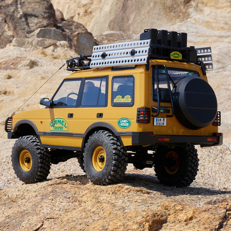 FMS FCX10 Land Rover Discovery RC Crawler - rear three-quarter action shot on rocks