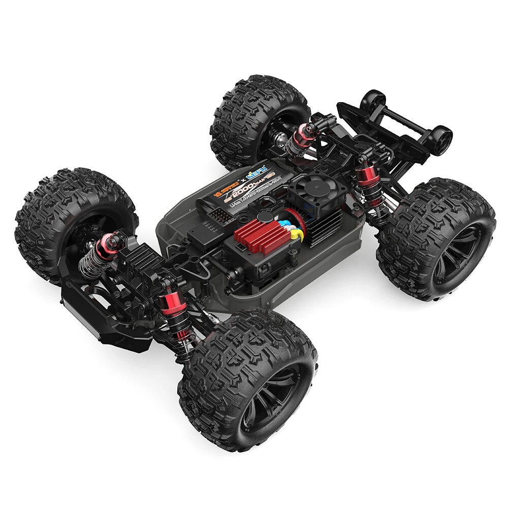 MJX Hyper Go 16218 chassis rear three quarter view with body removed showing 2S 2000mAh battery, 45A brushless ESC with red heat sink, cooling fan, 2845 brushless motor, red anodised oil filled shocks, wheelie bar and full metal drivetrain